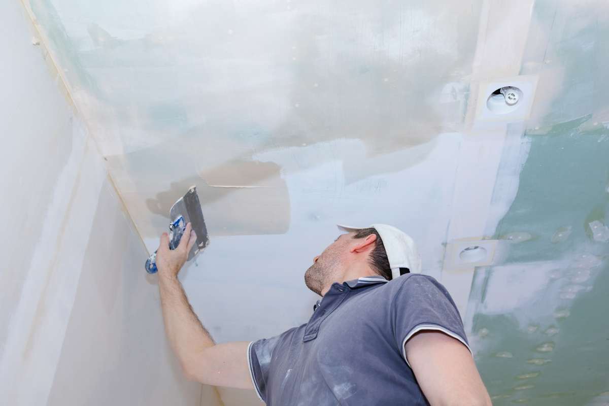 Worker make repairs in new apartment. Man plaster walls and ceilings. High quality photo
